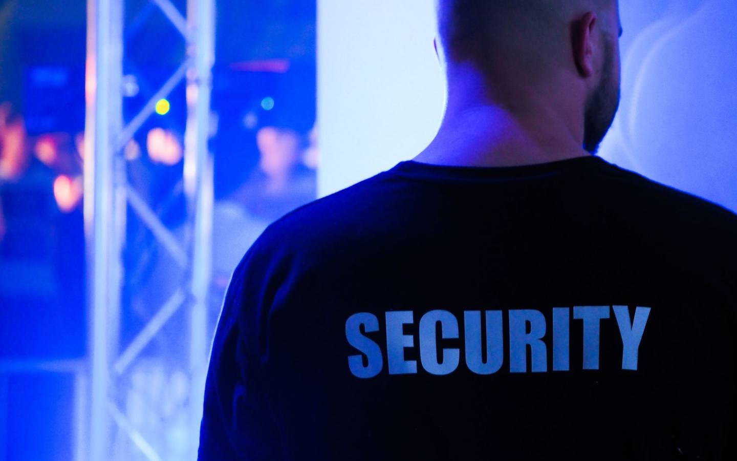 Security officer wearing a security jacket at an entrance