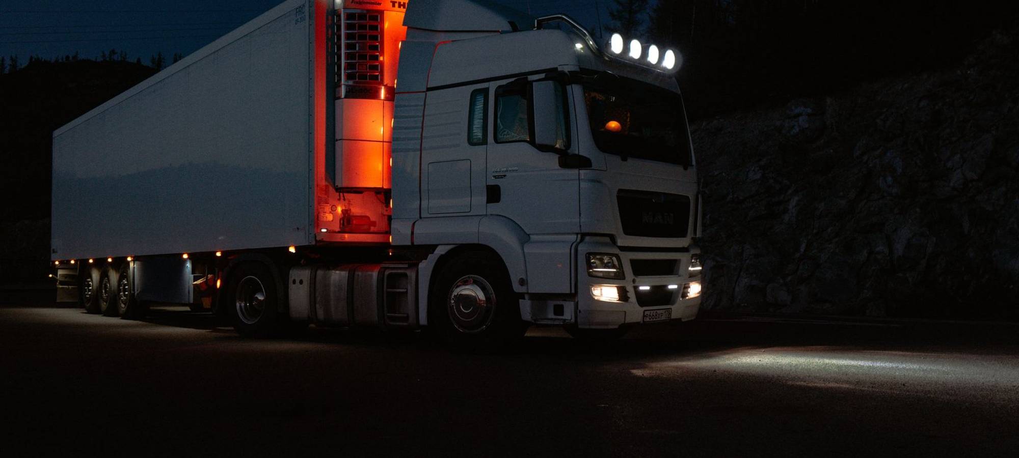 Illuminated entrance to a commercial site in the evening